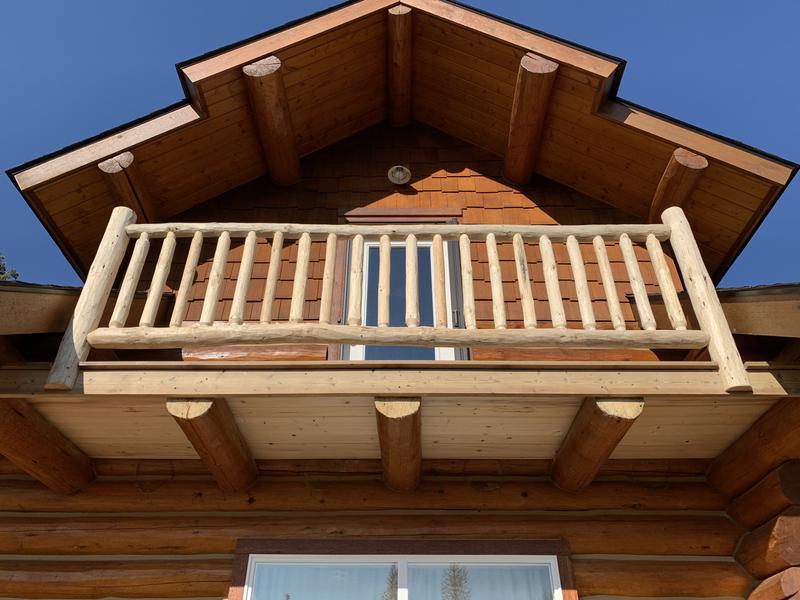 Log balcony under the gable